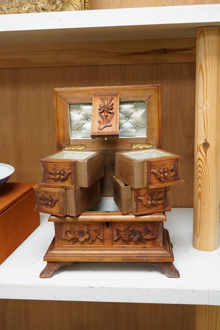 A 20th century black forest carved wood jewellery box, surmounted with two deer, 28cm high